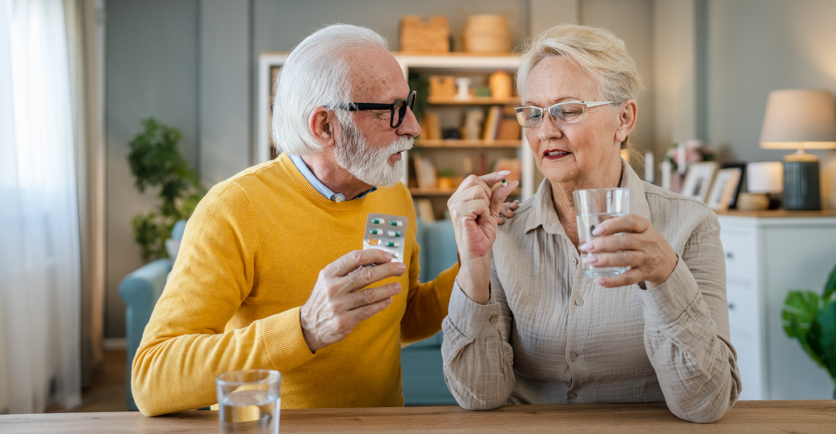 elderly couple taking supplements 