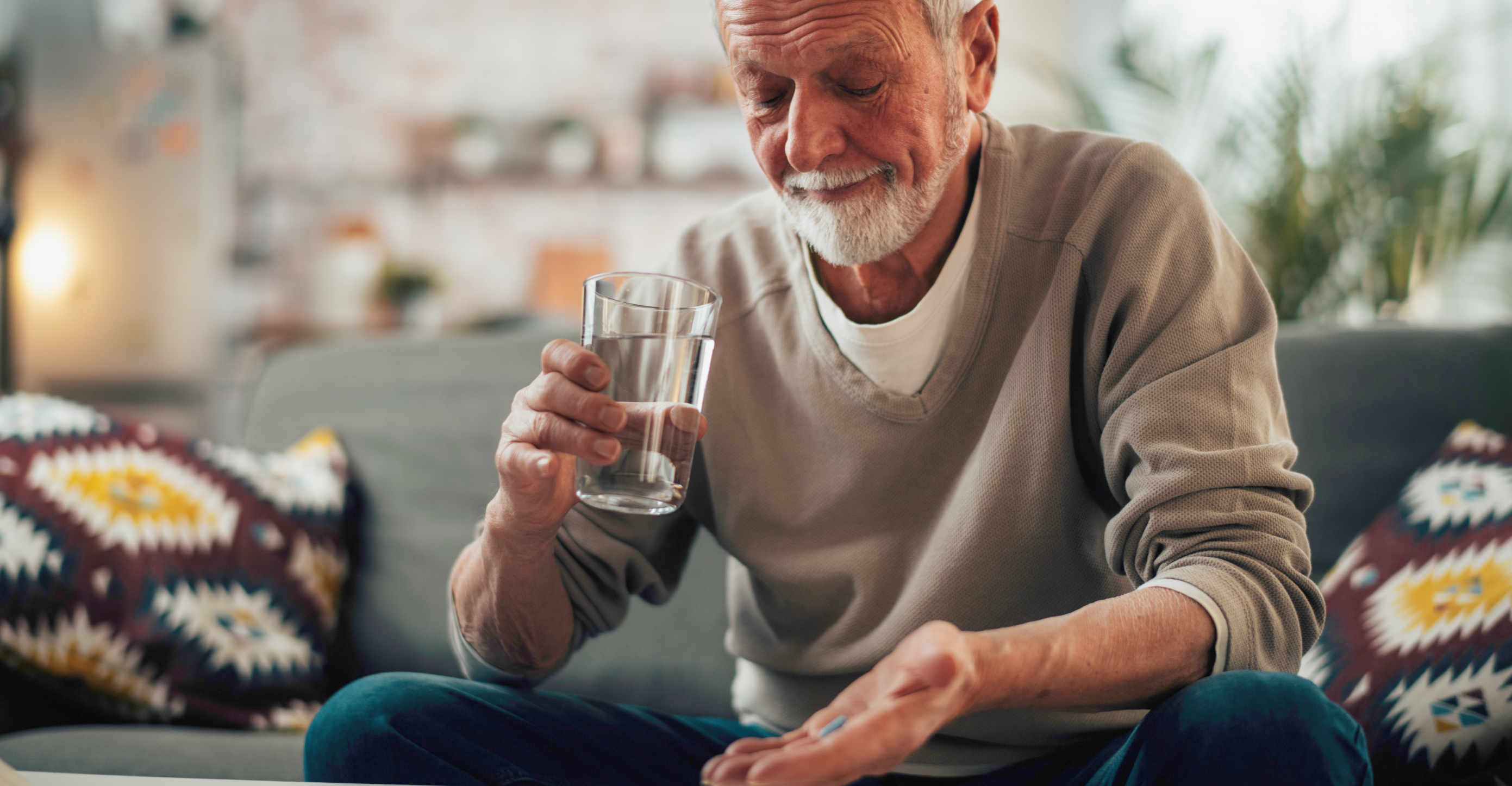 elderly man taking vitamins 