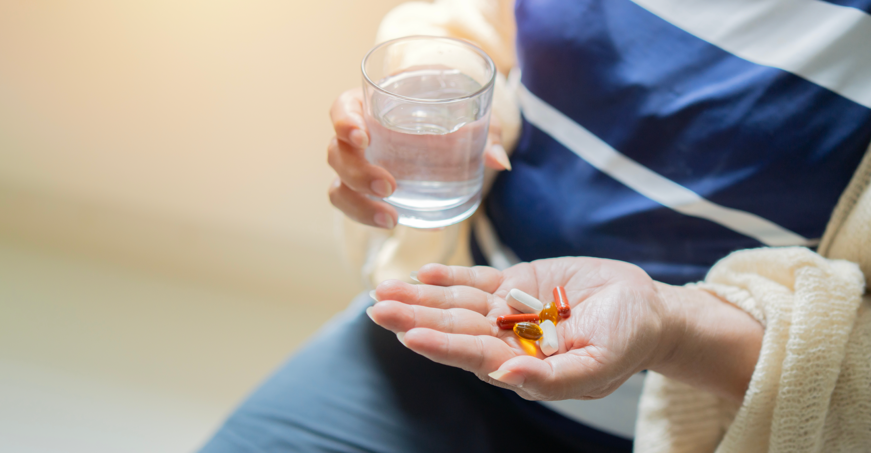 person with supplements in their hand 